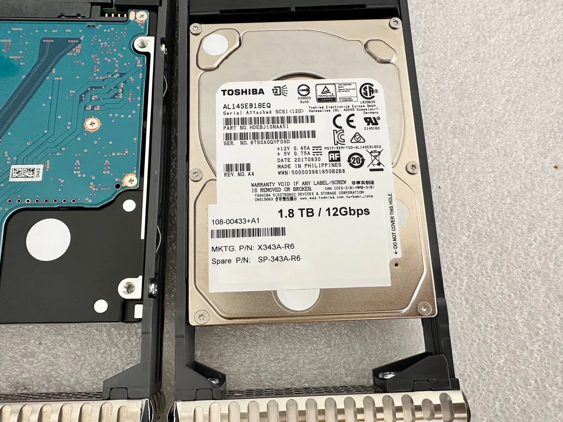 NetApp X343A-R6 1.8TB 12Gb SAS drive label on a Toshiba AL14SEB18EQ drive