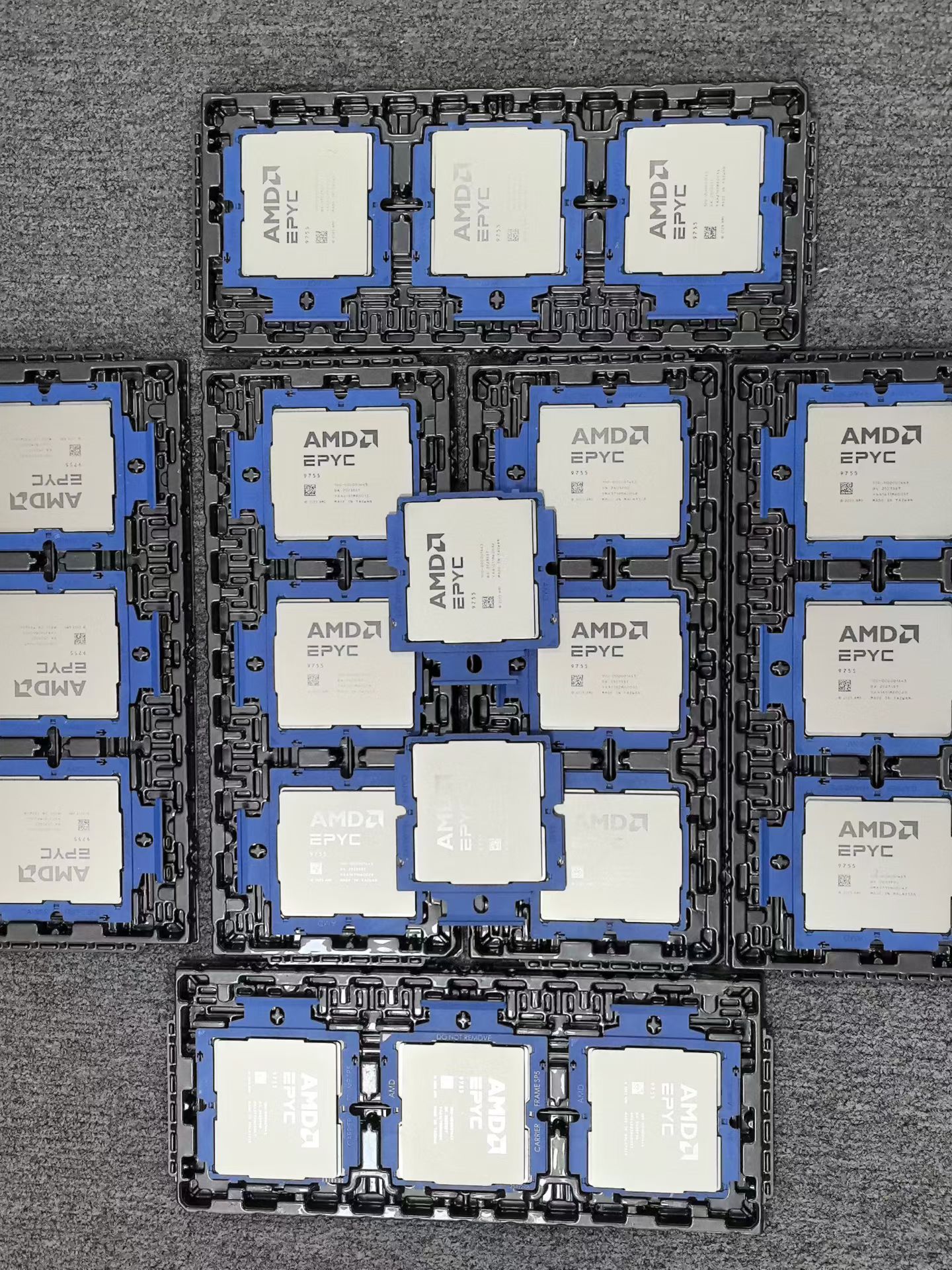 AMD EPYC server CPUs arranged in carrier trays for batch inspection